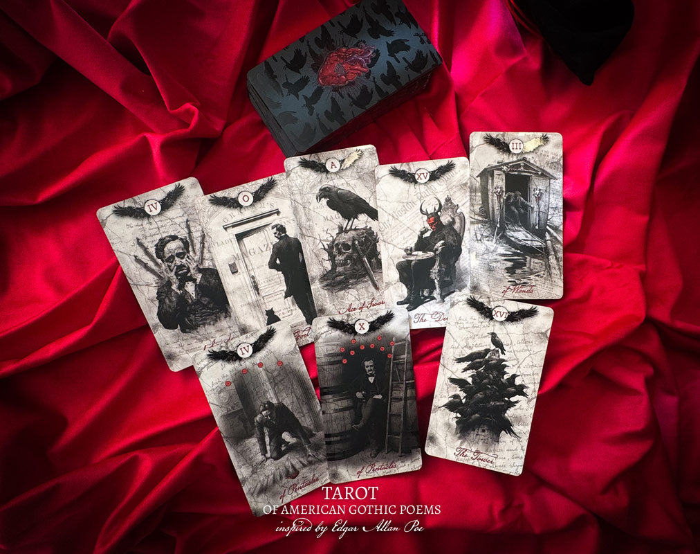 Set of tarot cards with gothic illustrations on a red fabric background