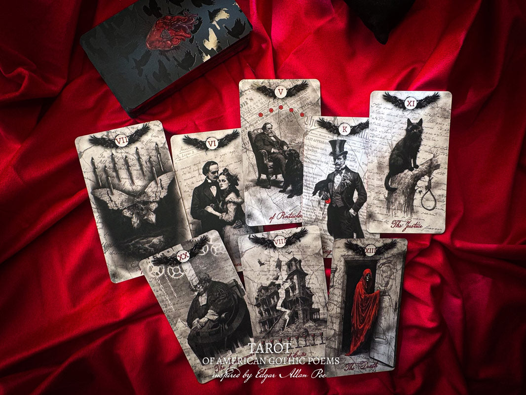 Set of tarot cards with gothic illustrations on a red fabric background