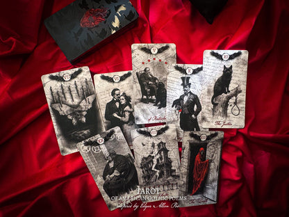 Set of tarot cards with gothic illustrations on a red fabric background