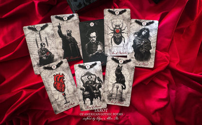 Set of tarot cards with gothic designs on a red fabric background