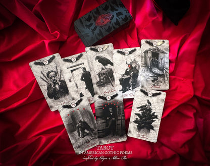 Set of tarot cards with gothic illustrations on a red fabric background