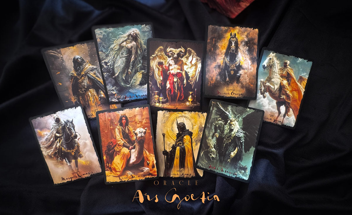 Collection of tarot cards with artistic illustrations on a dark fabric background, featuring the brand &
