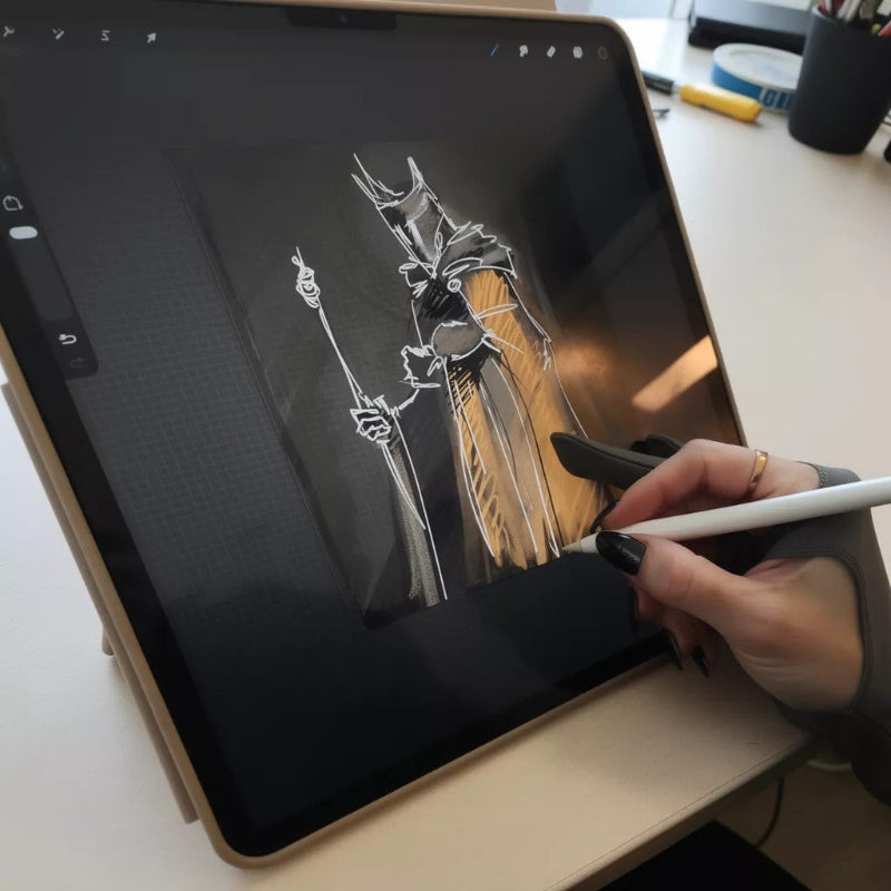 Person using a stylus to draw on a digital tablet with a black and white illustration of a character.